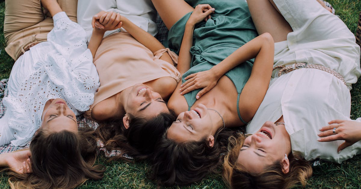 Overhead Shot of Women Lying on the Grass while Laughing