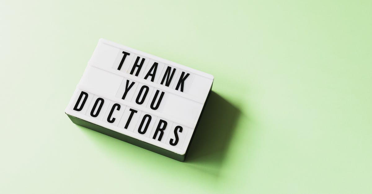 From above of vintage light box with THANK YOU DOCTORS inscription placed on green surface